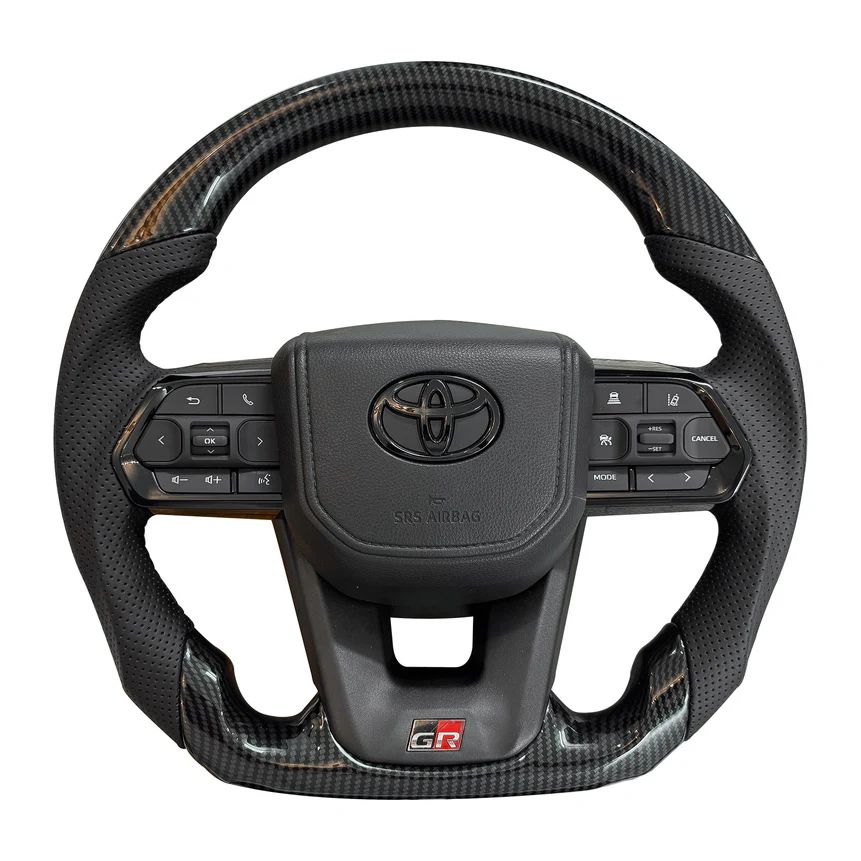 Carbon fiber steering wheel with Toyota logo on a white background