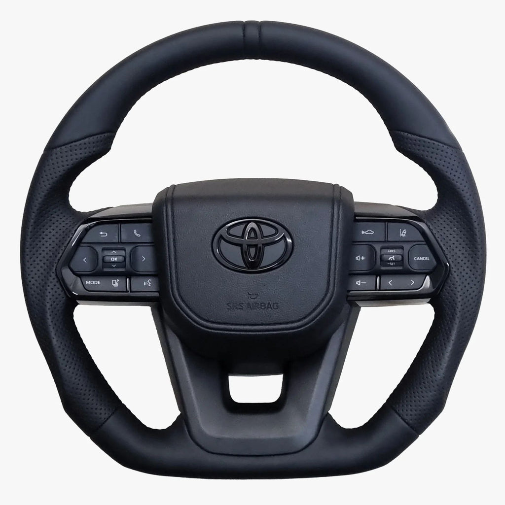 Black steering wheel with Toyota logo on a white background