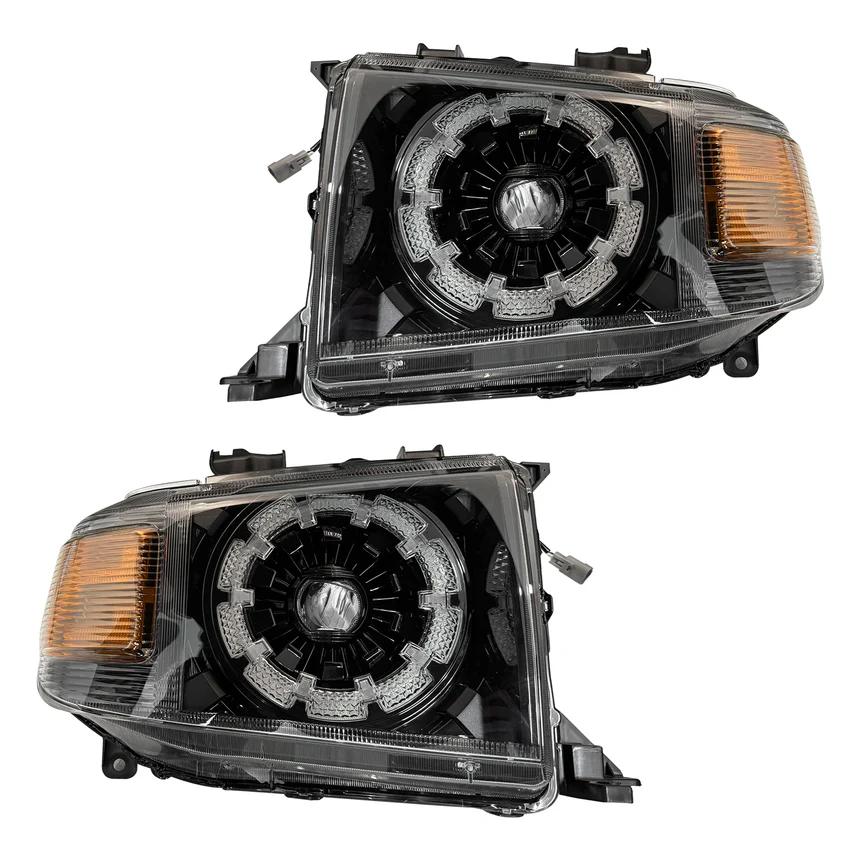 Two car headlight assemblies on a white background for Toyota